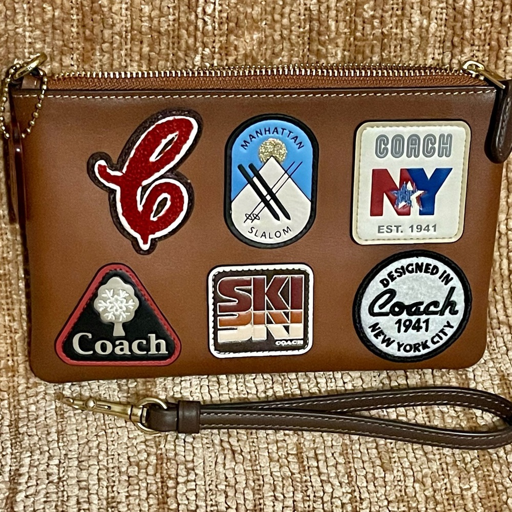 Coach Small Leather WRISTLET with Alpine-Inspired patches.